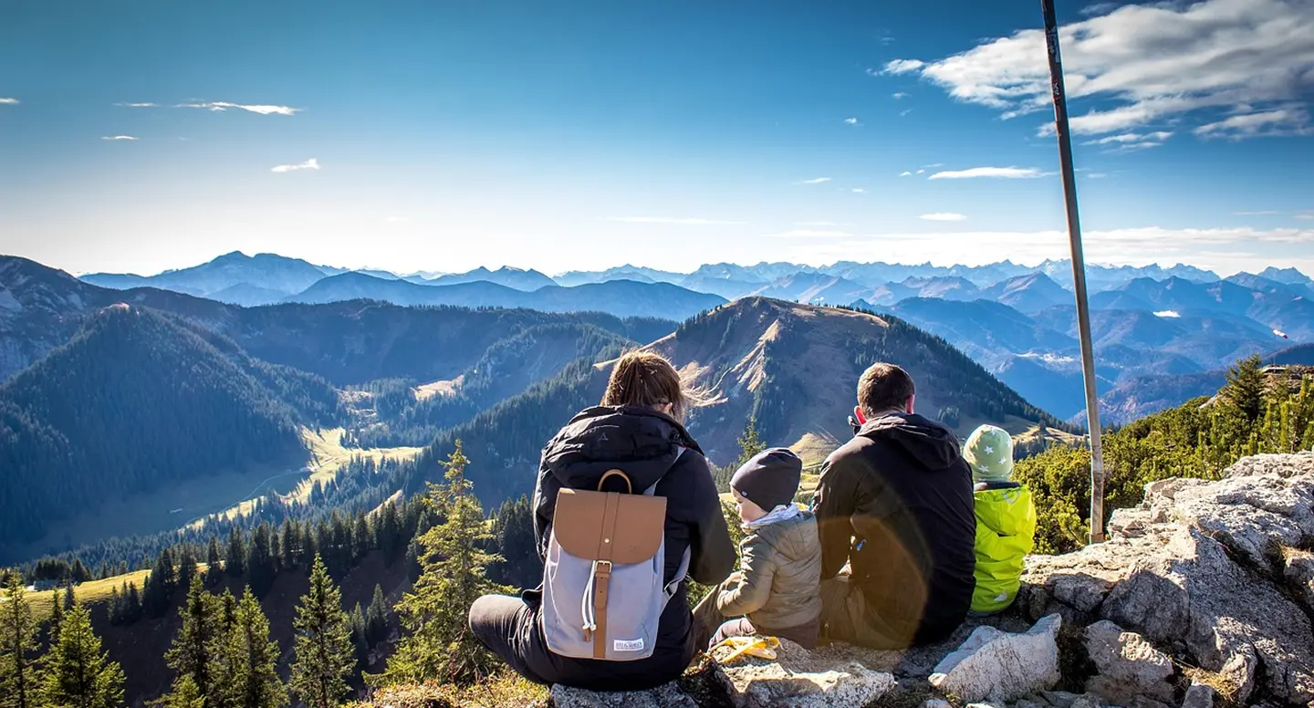 A family on a mountain enjoying the view